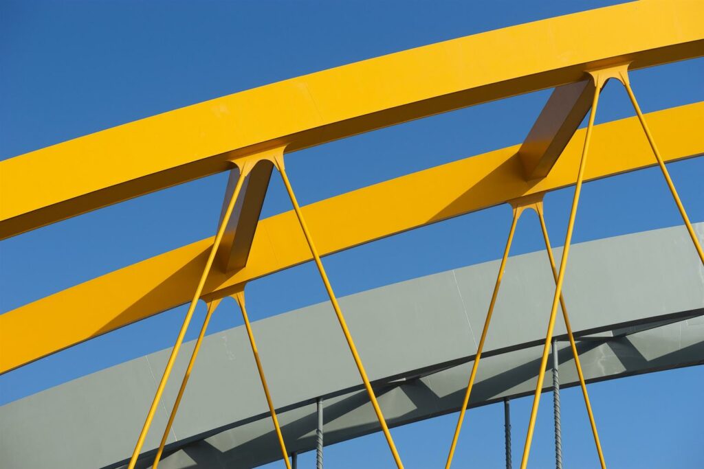 closeup-shot-yellow-metal-arch-blue-sky (Large)
