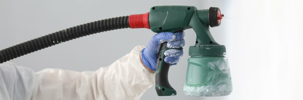 master-paint-wall-with-white-paint-male-hand-protective-suit-hold-spray-gun-his-hand-close-up (Custom)